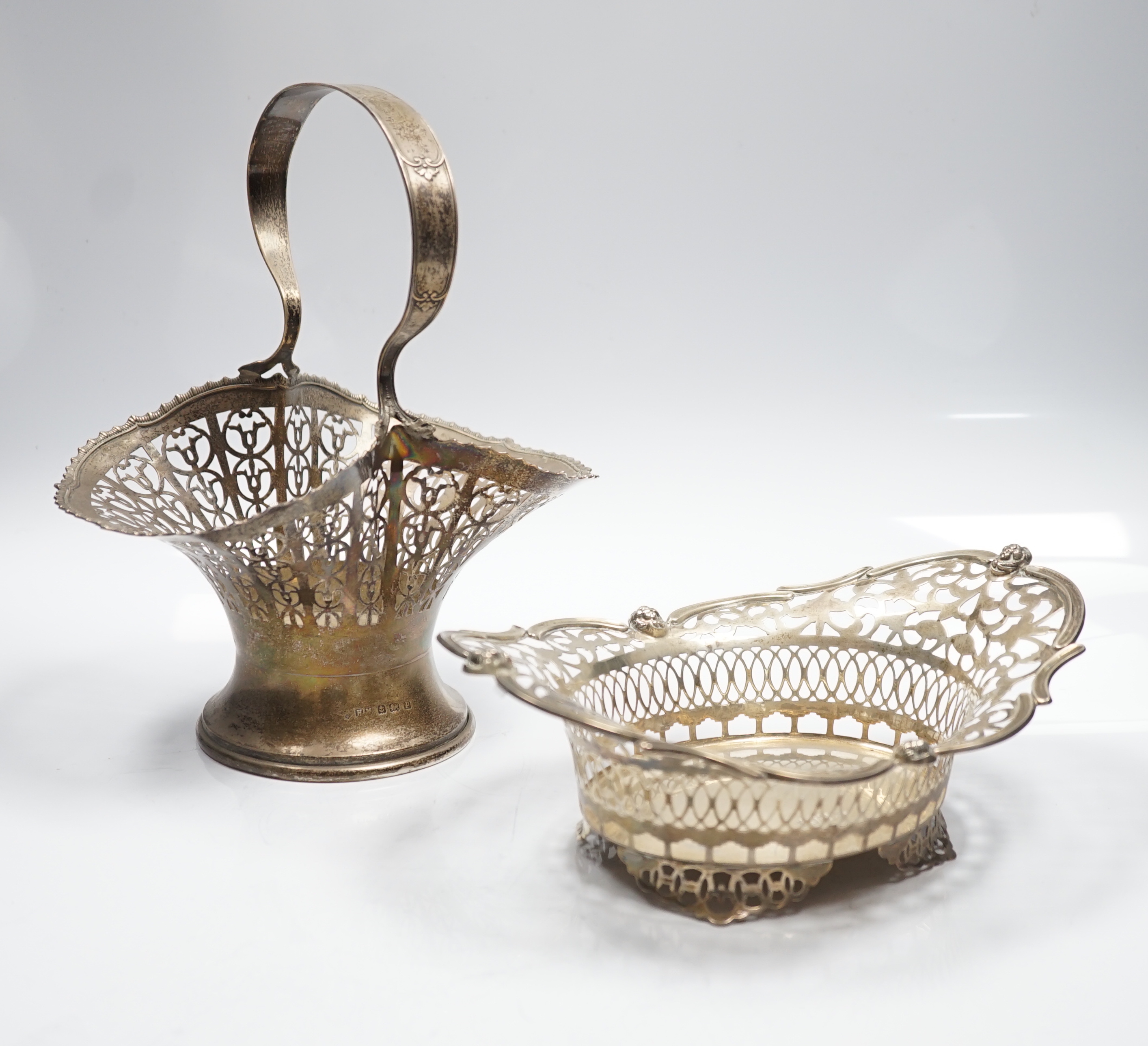 A George V pierced silver basket, Henry Matthews, Birmingham, 1914, height 23.7cm, together with a pierced silver oval dish, London, 1912, 14.1oz.